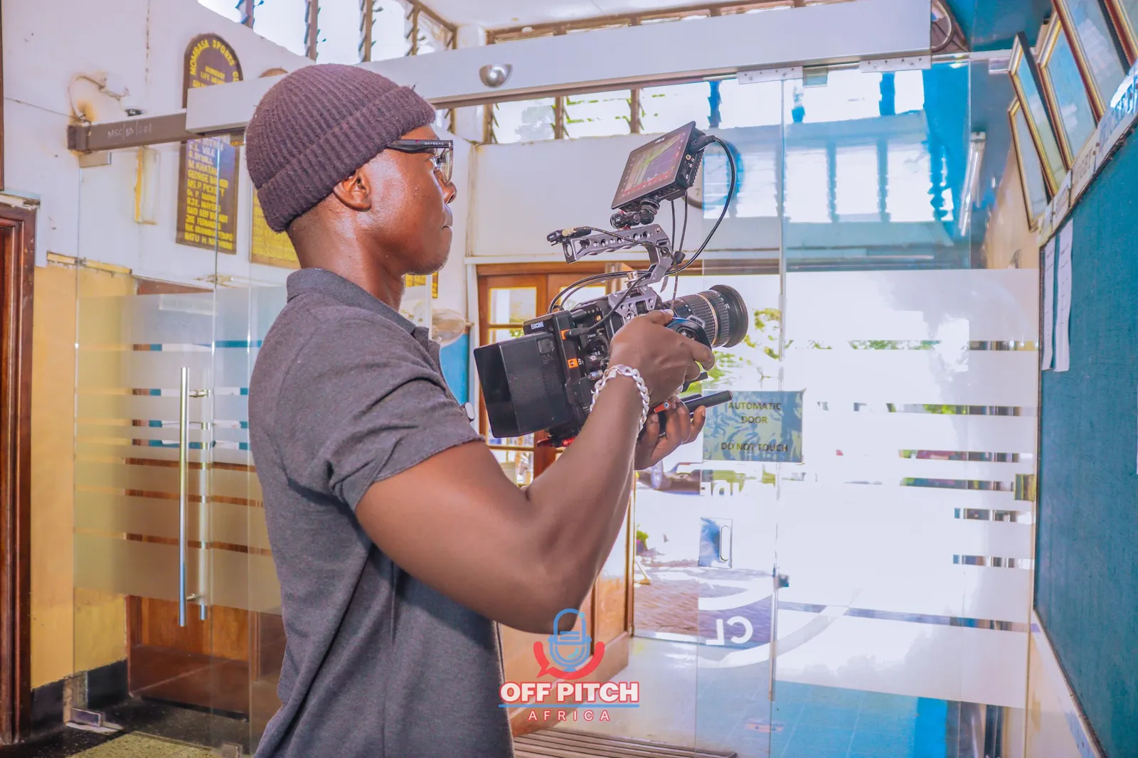 Off Pitch Africa camera operator filming at the Mombasa Sports Club entrance