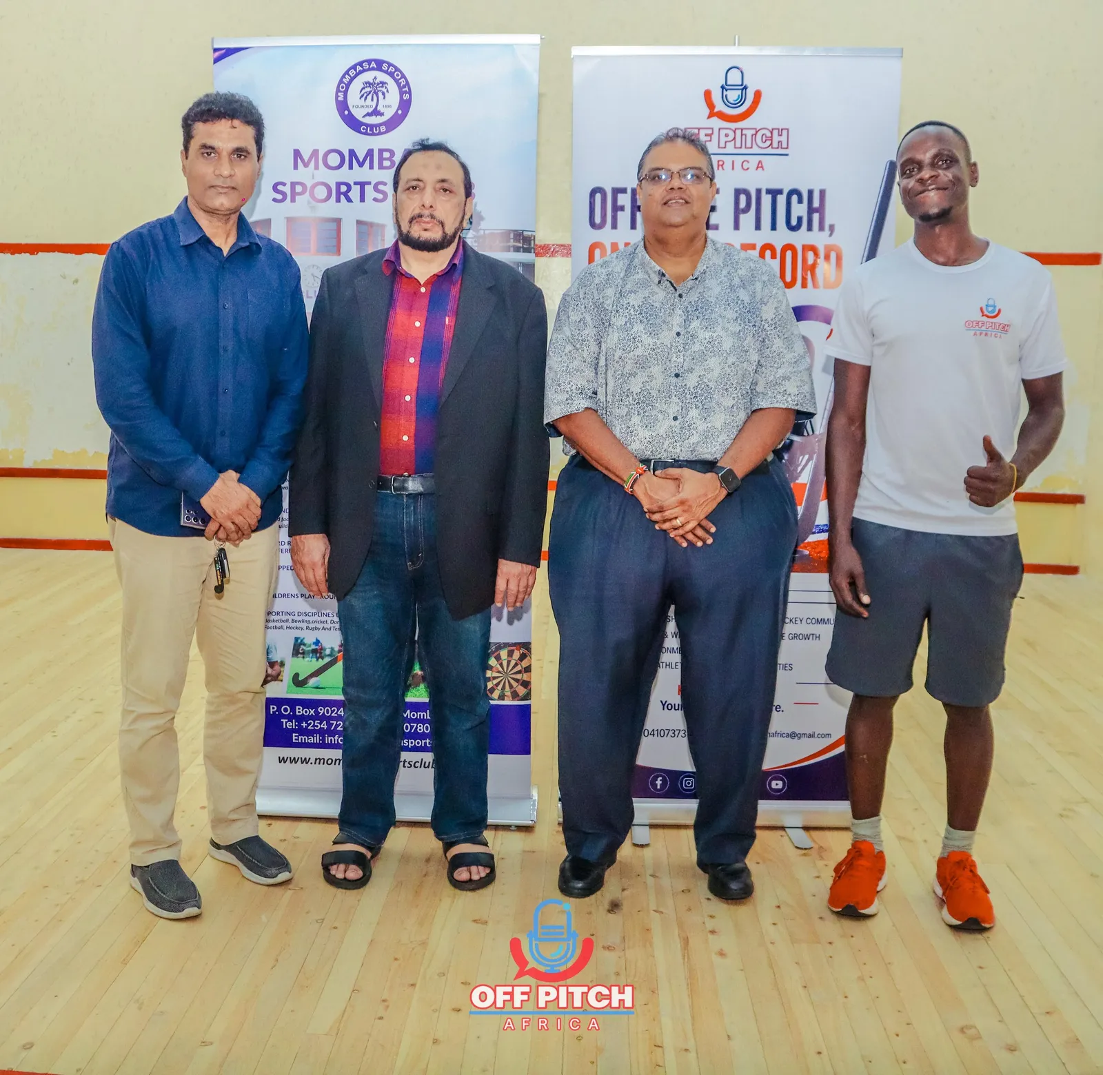 Guests and the Off Pitch Africa host standing in front of event banners
