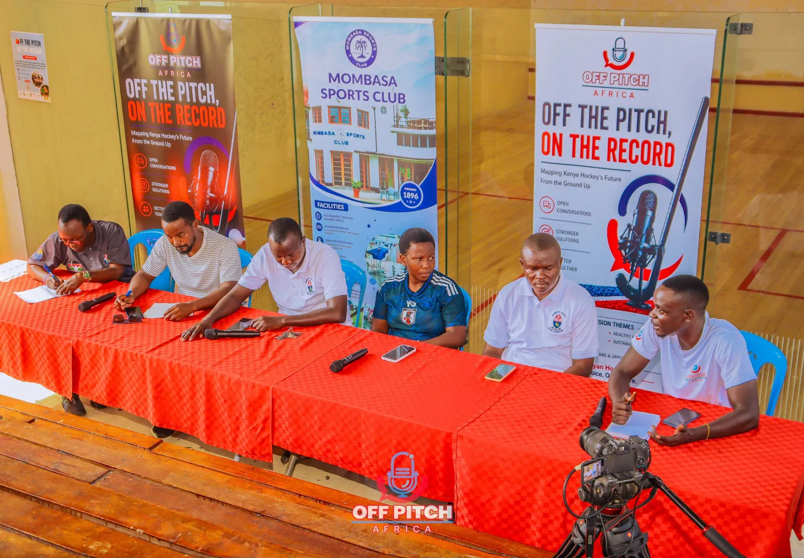 Panel table seen from above, with Off Pitch Africa and Mombasa Sports Club banners behind it