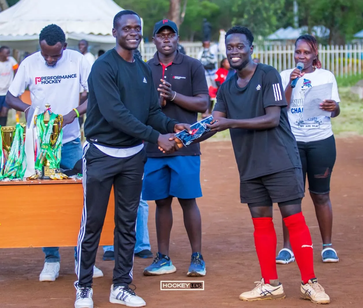 Team celebrating with trophies at an event